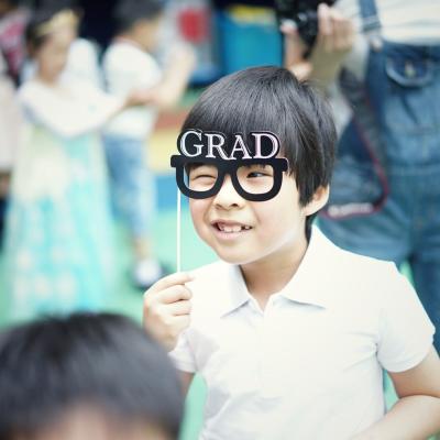 child with grad glasses