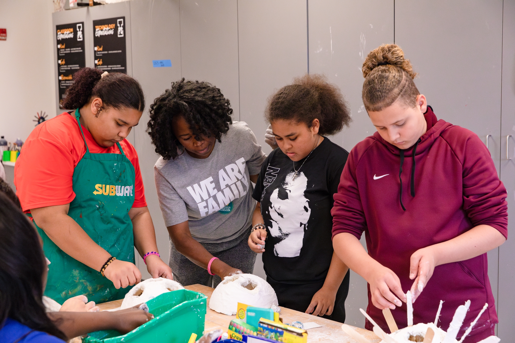 Students working with a professional artist