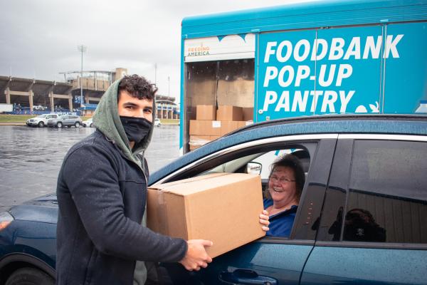 A volunteer and a recipient at an Akron-Canton Regional Foodbank event