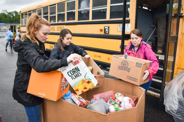 Akron-Canton Regional Foodbank volunteers help to pack up a bus