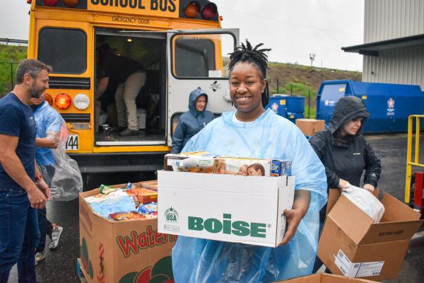 Akron-Canton Regional Foodbank volunteers help to pack up a bus