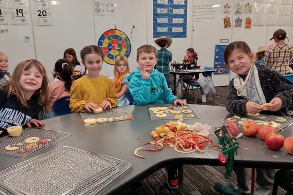 Students peeling and slicing apples