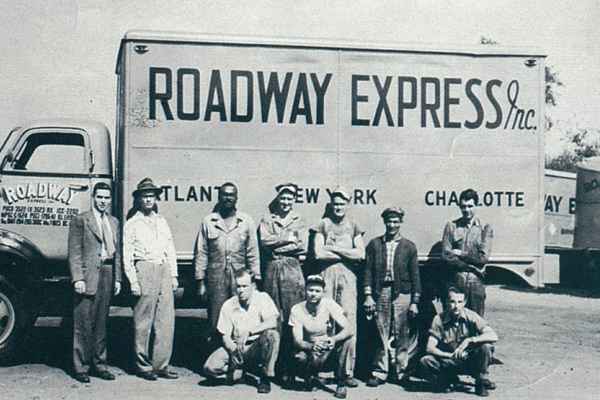 Roadway employees in front of a truck