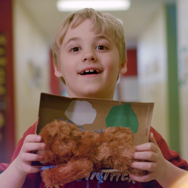 Screenshot of first grade APS scholar with Akron Zoo bear