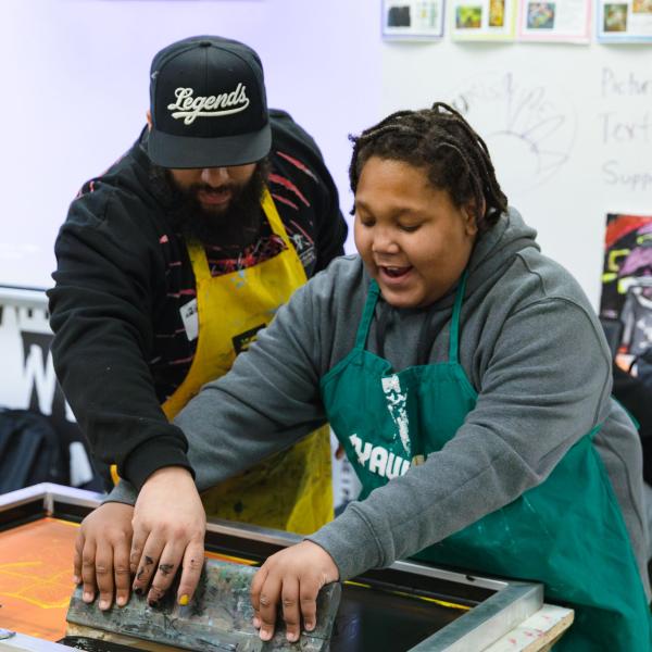 Student working with artist. Photo by Julian Curet