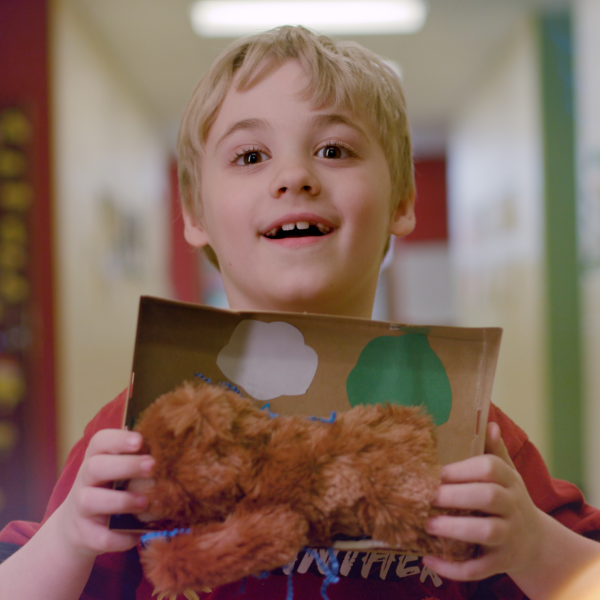 Student holding a bear habitat to represent the Akron Zoo experience