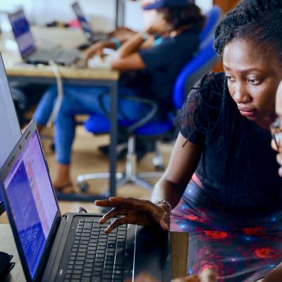 people looking at code on computer
